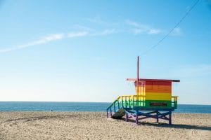 a lifeguard stand on the beach with the ocean in the background